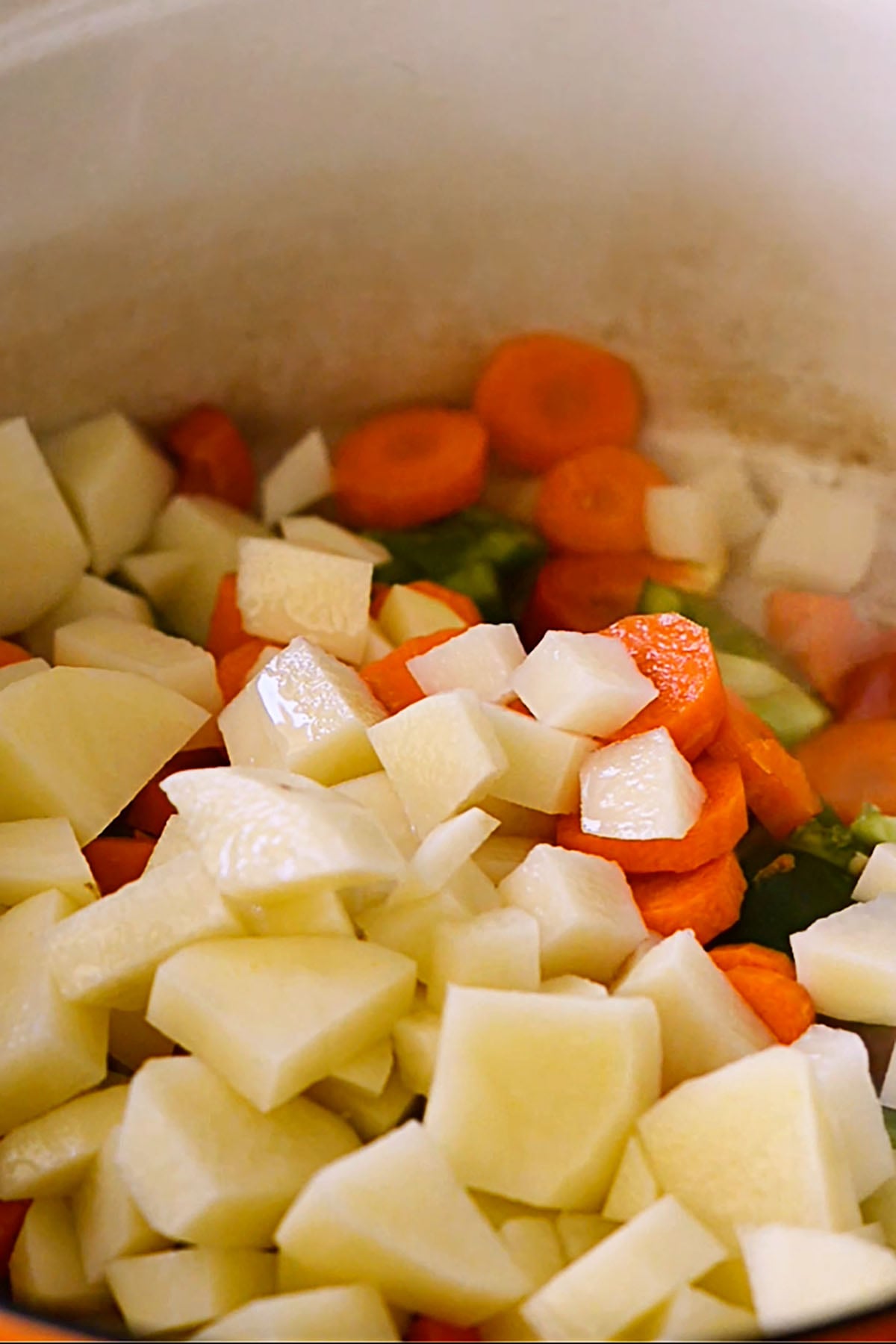 Vegetables sautéing in a cast iron dutch oven.
