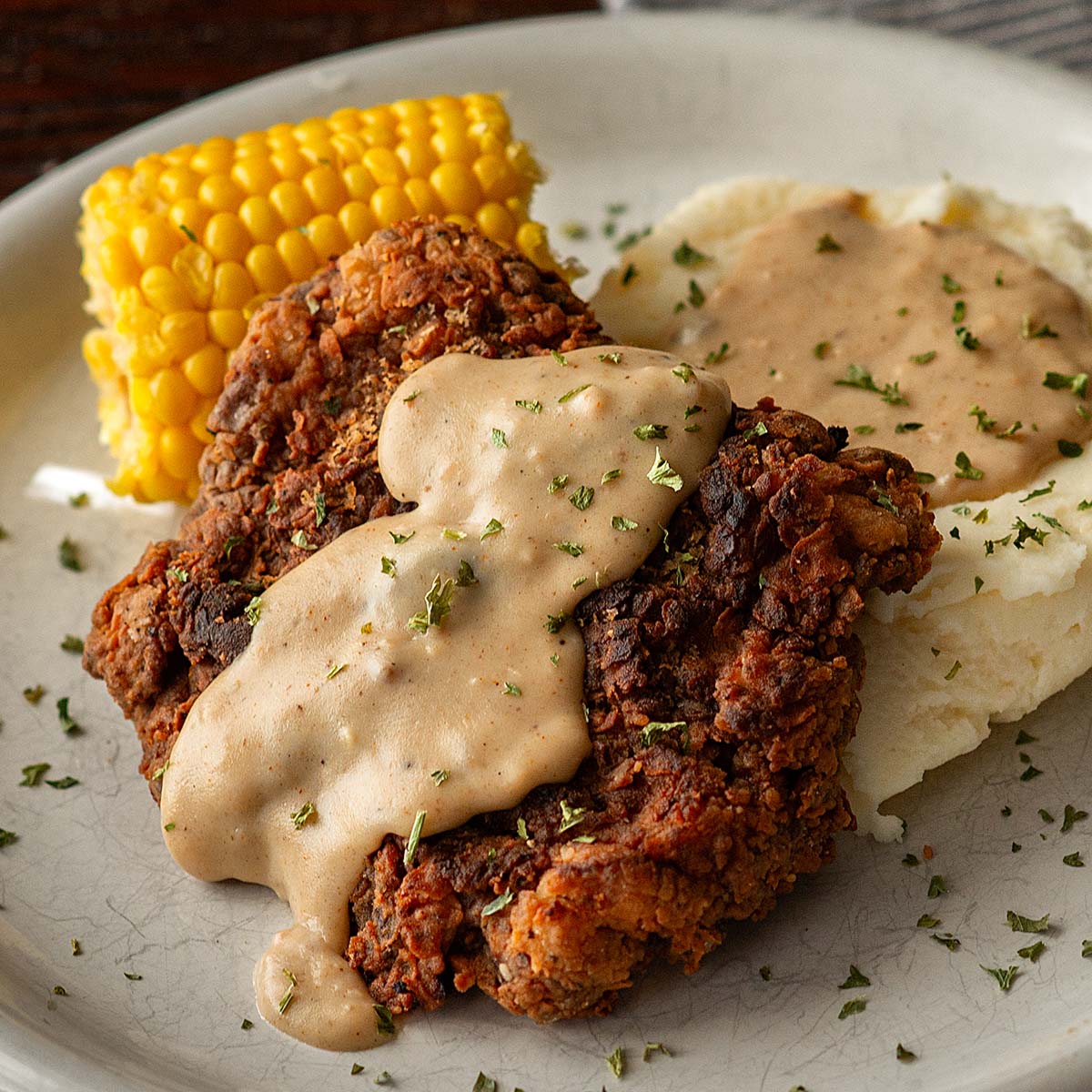 Chicken Fried Steak with Cream Gravy served with Mashed Potatoes and Corn on the Cob.