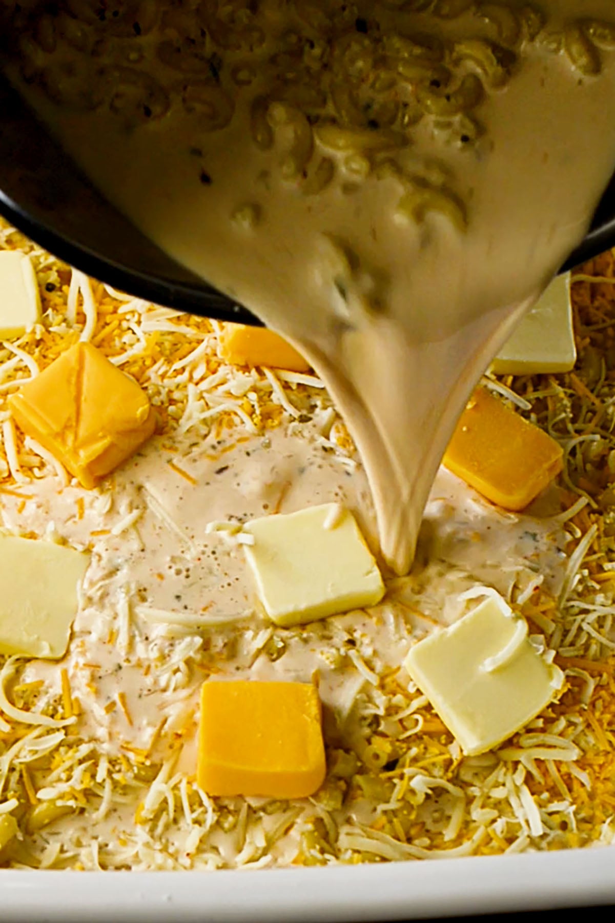 Cubed Velveeta Cheese and Butter in a creamy macaroni mixture.