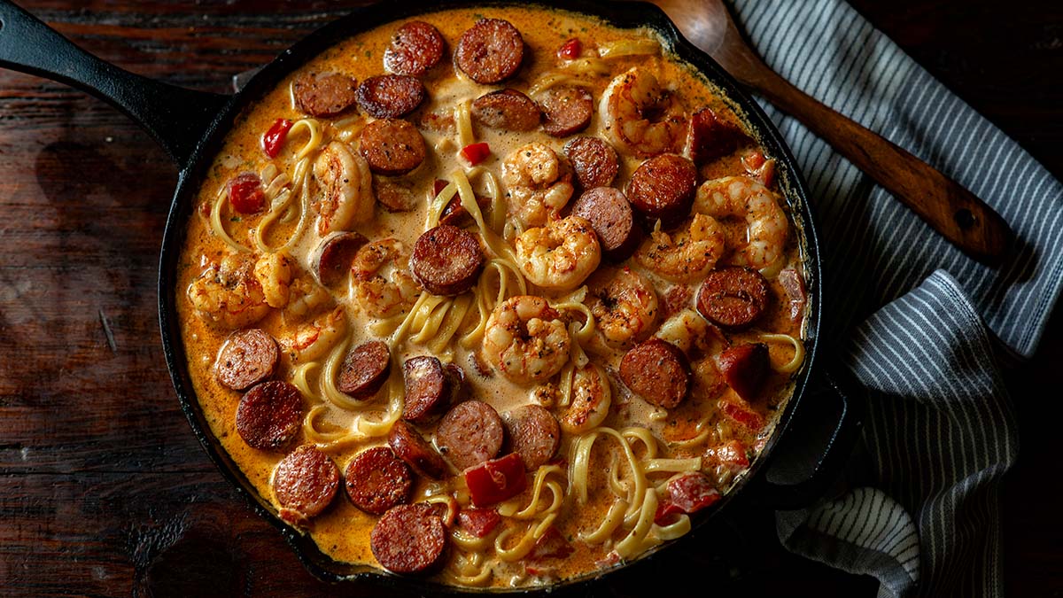 Cajun Shrimp and Sausage Pasta in a cast iron skillet.