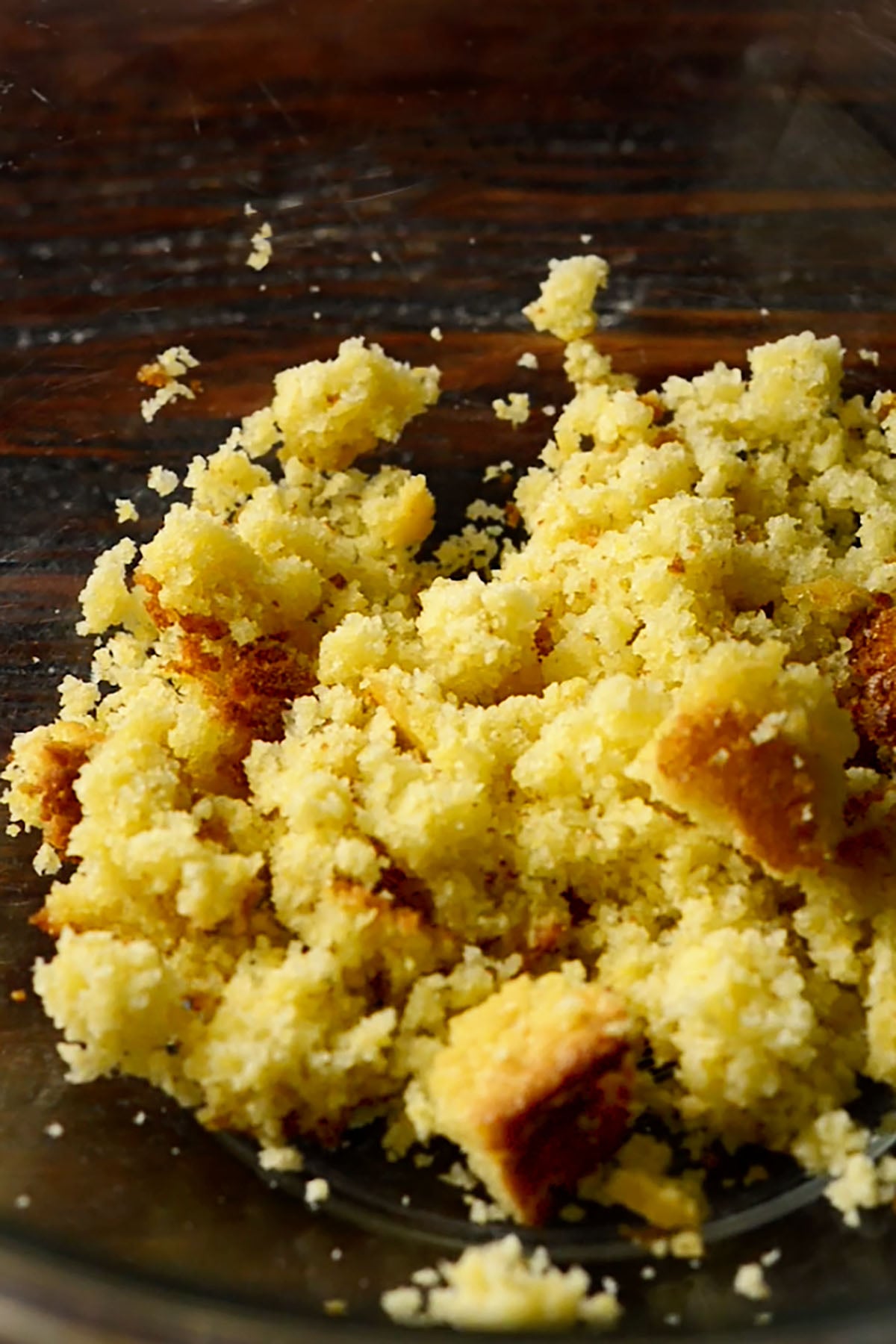 Crumbled cornbread in a mixing bowl.