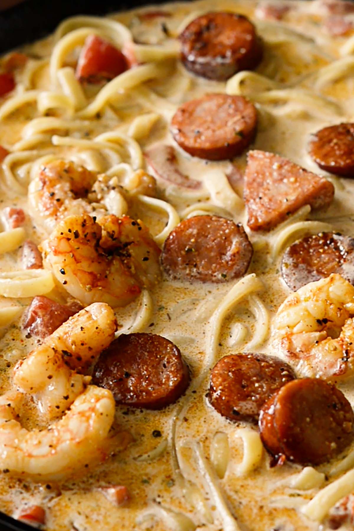 Cooked smoked sausage and shrimp in a creamy cajun pasta dish.