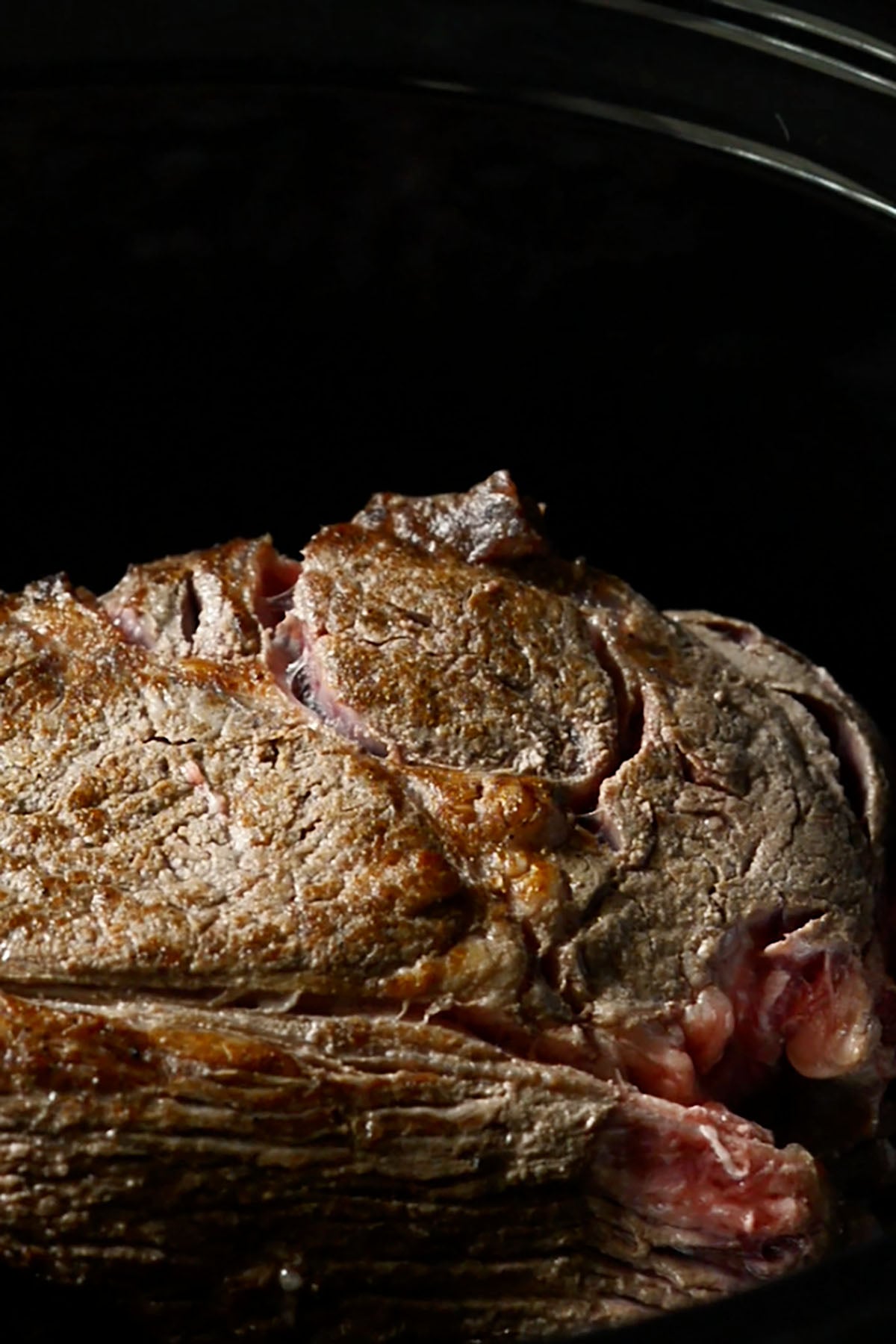 A seared chuck roast in a slow cooker.
