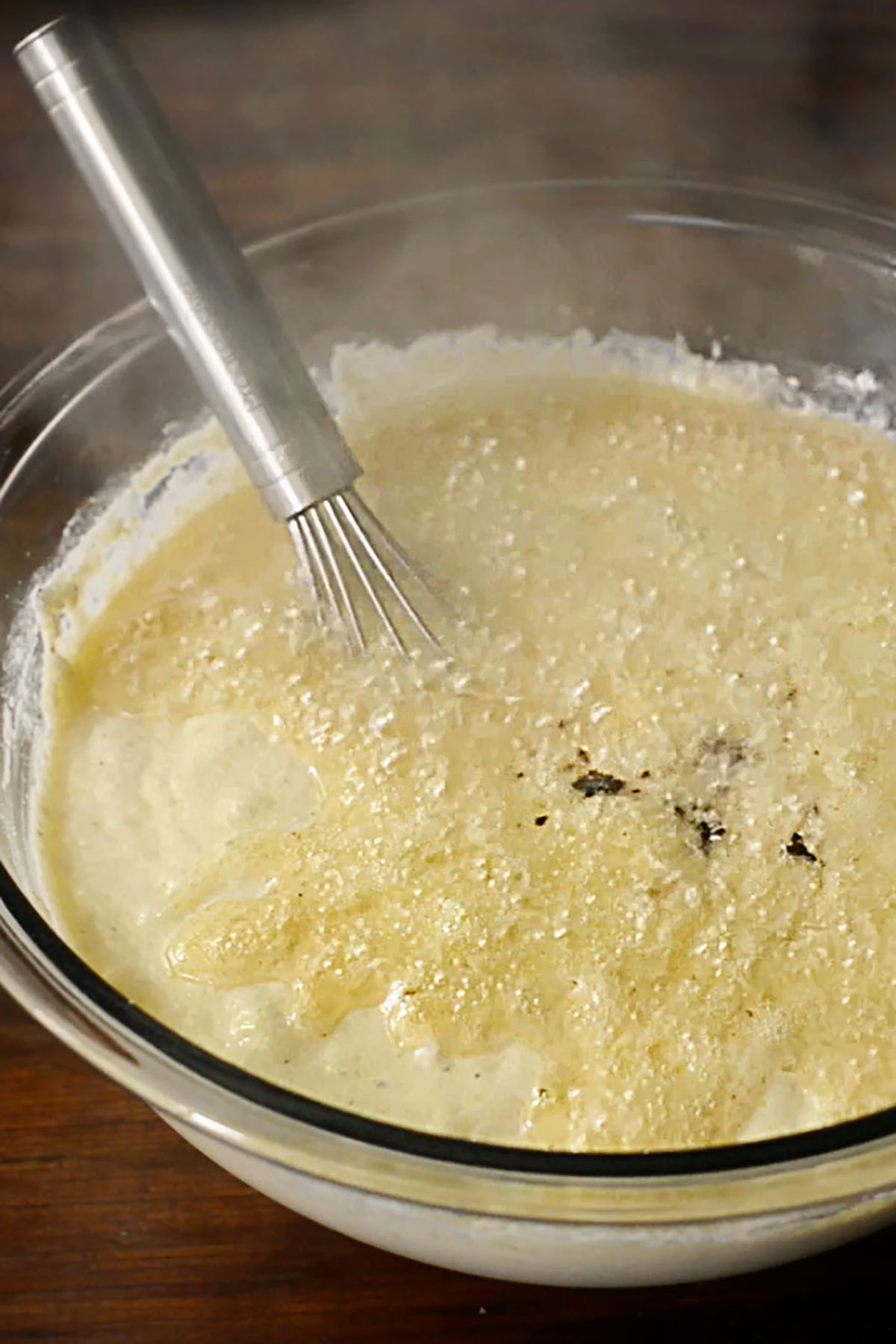 Hot bacon grease poured over a mixing bowl full of southern cornbread batter.