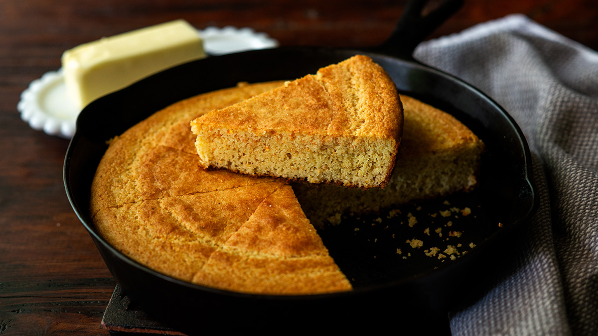 Classic Southern cornbread baked in a cast iron skillet and served sliced with softened butter.