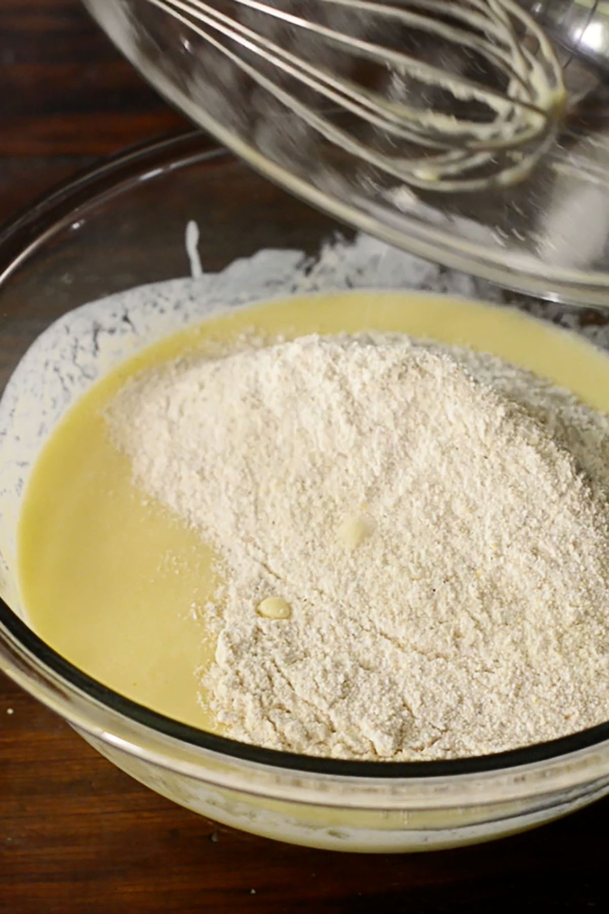 Cornmeal being stirred into an egg and buttermilk mixtures for southern cornbread.