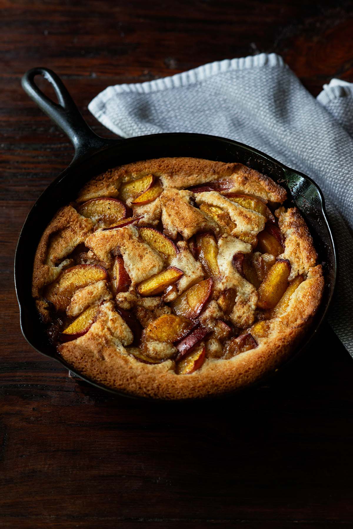 Baked Southern peach cobbler in a cast iron skillet.