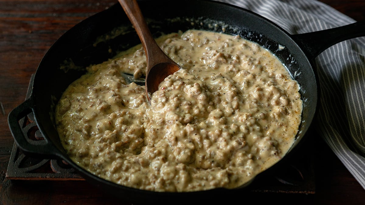 Creamy sausage gravy in a cast iron skillet.