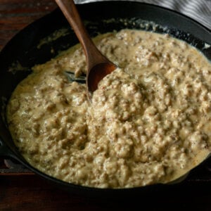 Thick and hearty Southern sausage gravy served in a cast iron skillet.