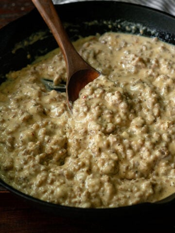 Thick and hearty Southern sausage gravy served in a cast iron skillet.