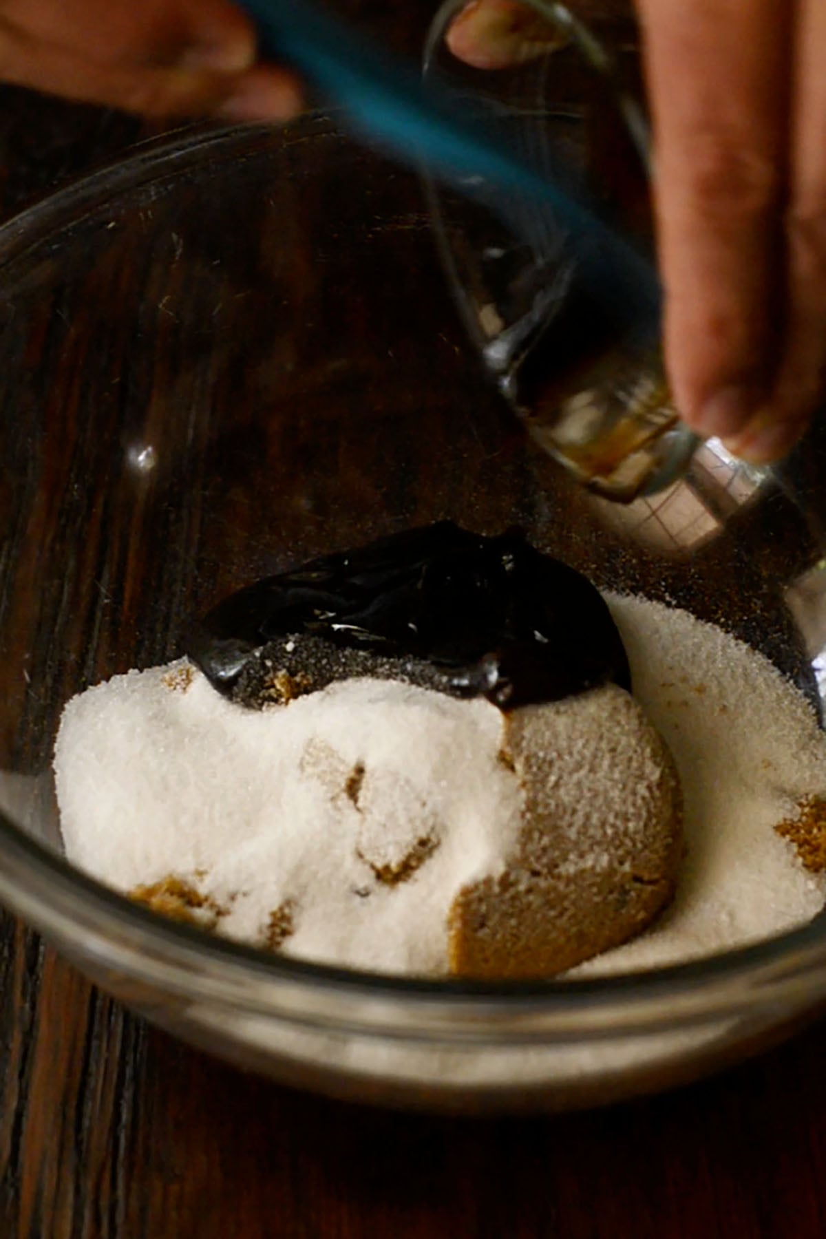 Bourbon chicken sauce being mixed together in a glass mixing bowl.