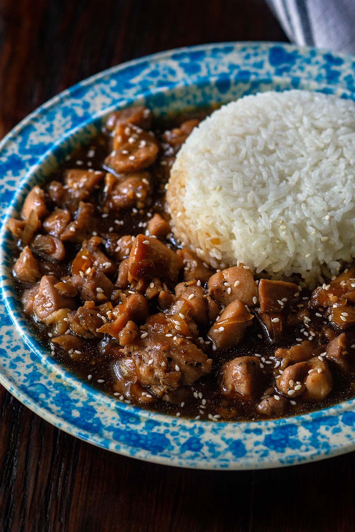 Bourbon Chicken served in a vintage bowl with steamed white rice.