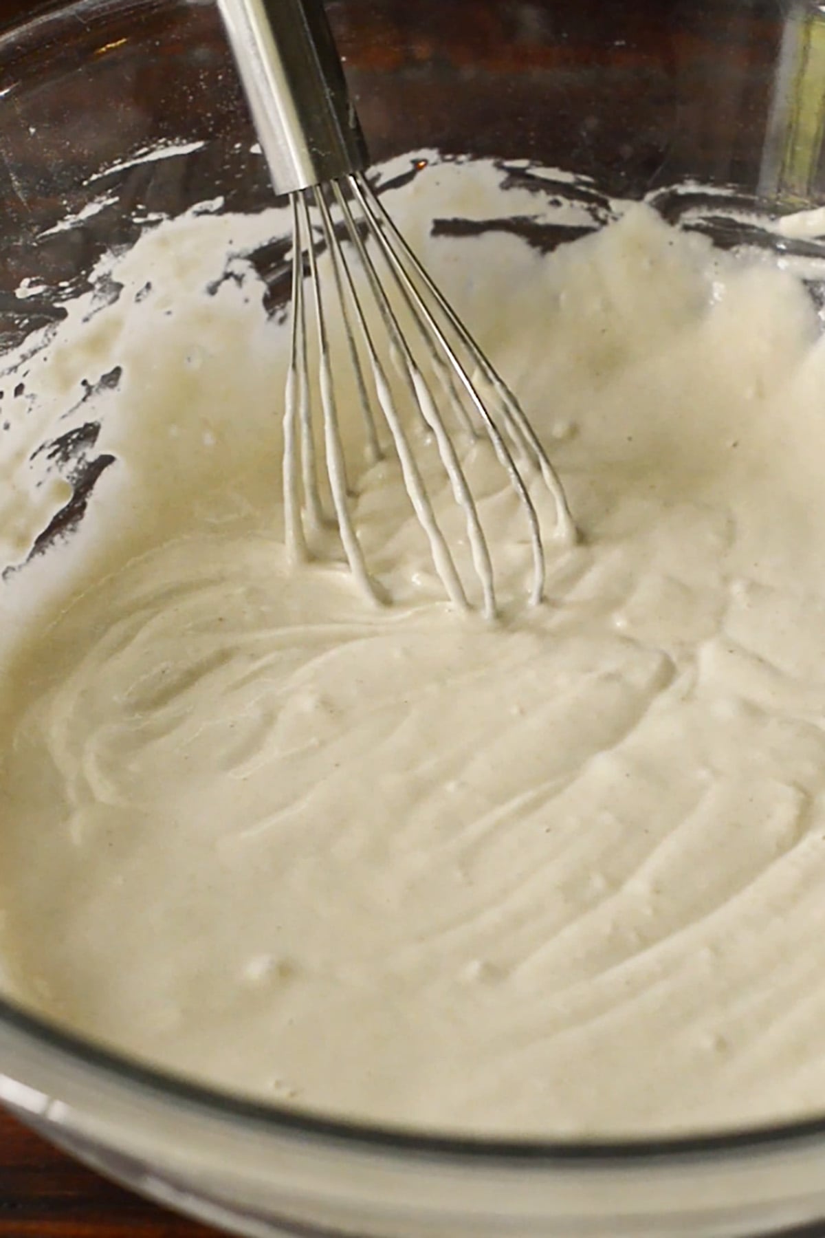 Copycat Long John Silver's fish batter whisked together in a glass mixing bowl.