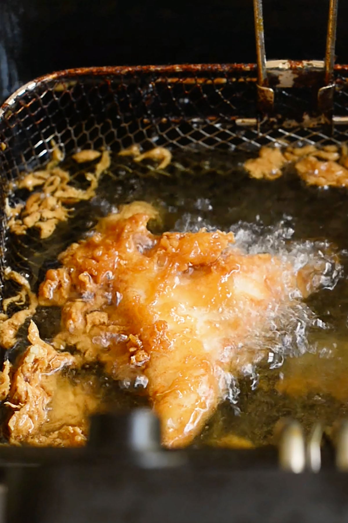 Copycat Long john Silver's fish frying in a deep fryer.