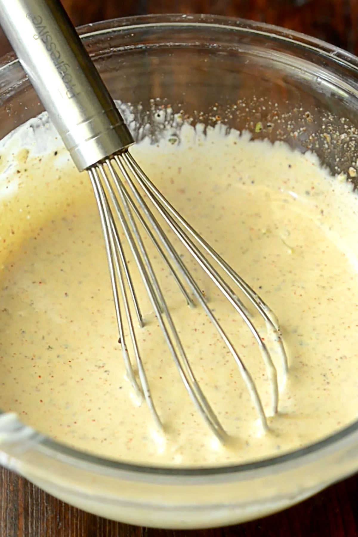 Cajun remoulade fully whisked together in a glass mixing bowl.