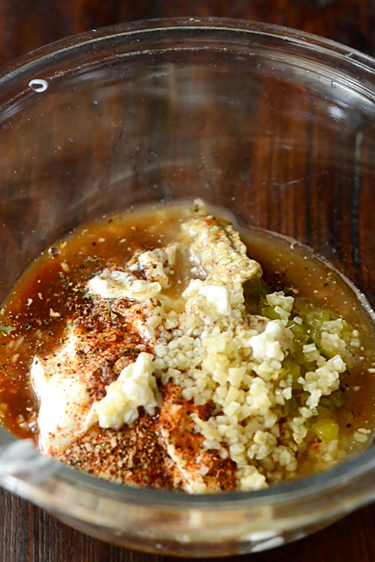 Cajun remoulade ingredients in a glass mixing bowl.