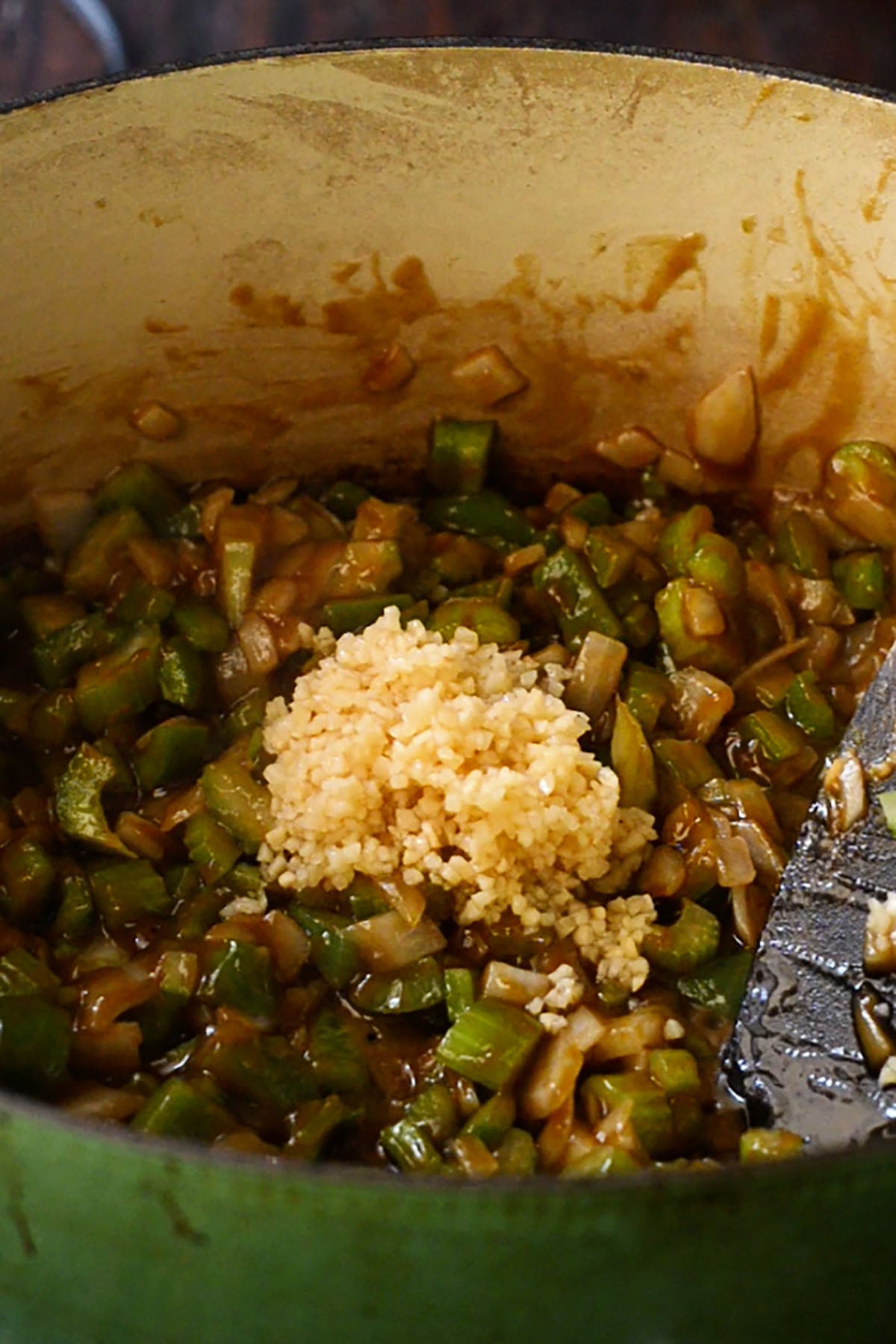 Vegetables for the Holy Trinity and fresh minced garlic stirred into a dark gumbo roux base.